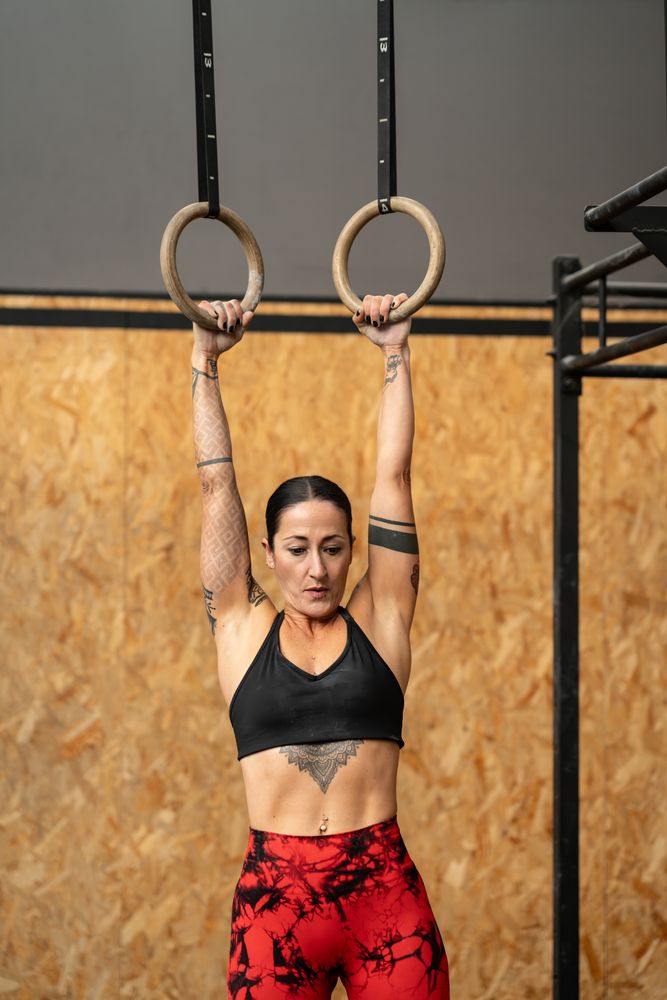 Woman working out with gymnastic rings in the gym