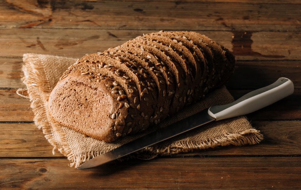 Freshly baked rye bread on napkin on table