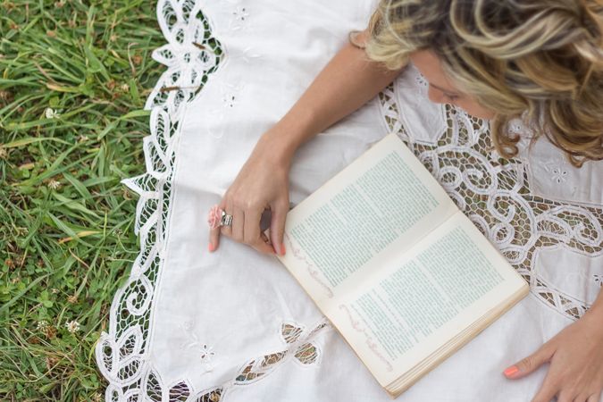 woman with book on the grass