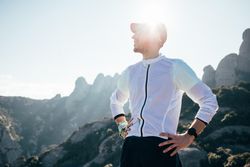 Male athlete resting after training on sunny day