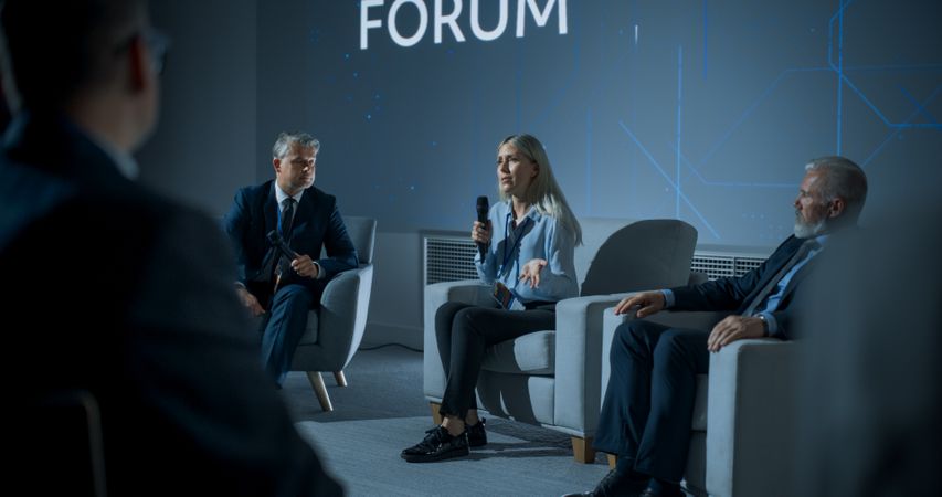 International Technology Conference: Male Host Asking Female CEO a Question In Front Of Audience.
