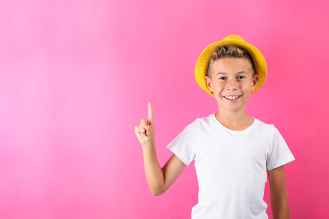 Boy with hat against color background, space for text