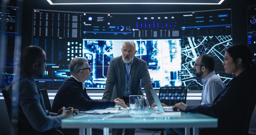 Chief Software Engineer Showing a Satellite Tracking Technology Capabilities to a Group of High Profile Government and Cybersecurity Officials.