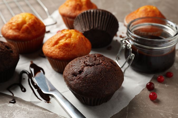 Composition with delicious muffins, berries, chocolate and baking paper