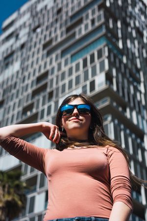 Stylish woman standing at modern building