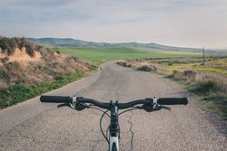 Bicycle on road in desert hills