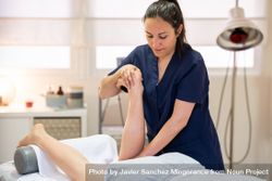 Medical massage on leg on massage table bE6mV0