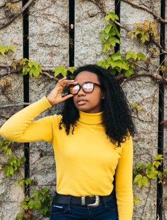 portrait of a Black woman with reflective  sunglasses