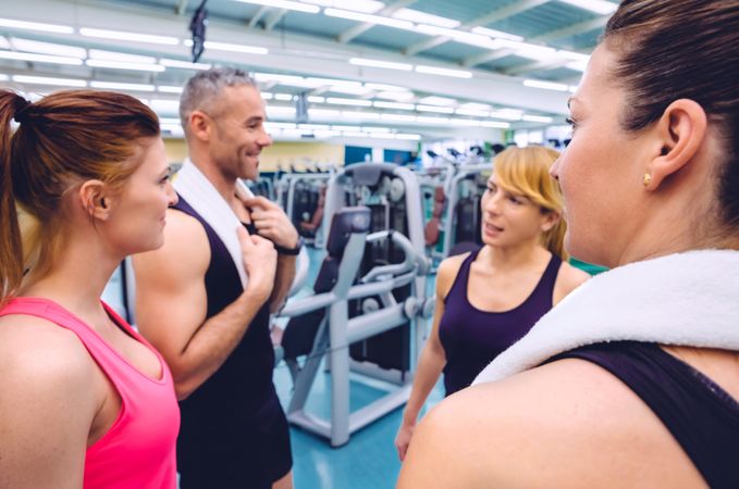 Fit people talking together in gym after workout
