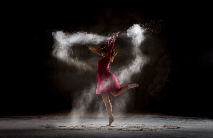 Young woman between fog in darkness