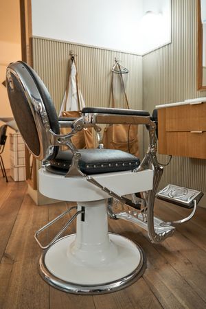 Empty leather chair in barbershop