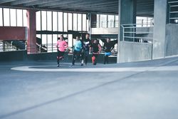 Group of people running up a winding track