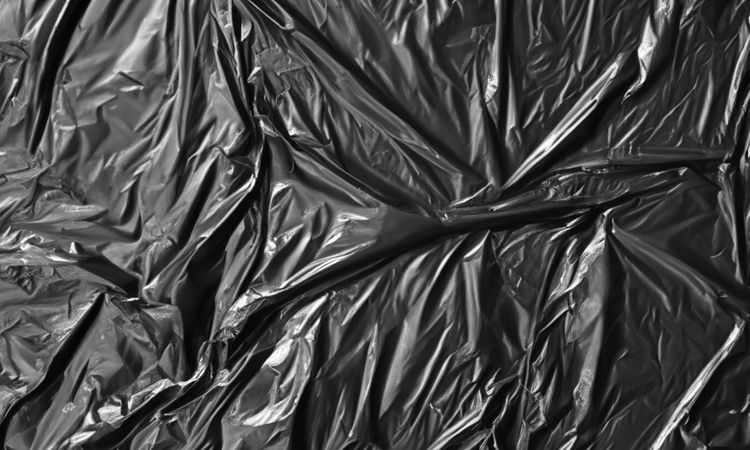 dark crumpled and creased plastic poster texture background