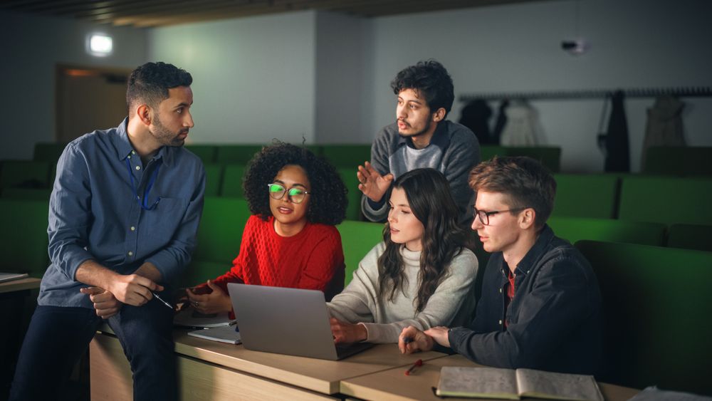 Group of Diverse Happy Students Having a Conversation in University Classroom