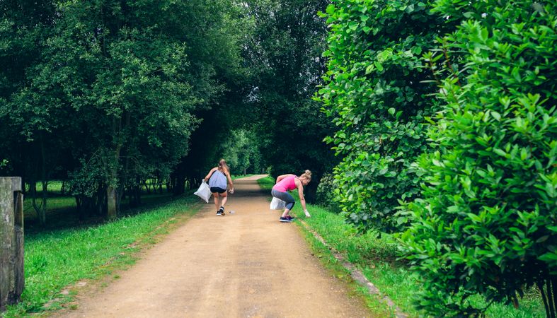 Two women on back doing plogging