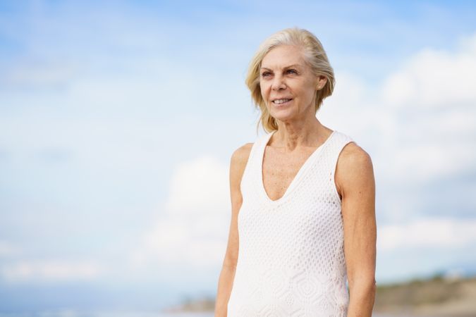 Smiling older female on a windy day in nature