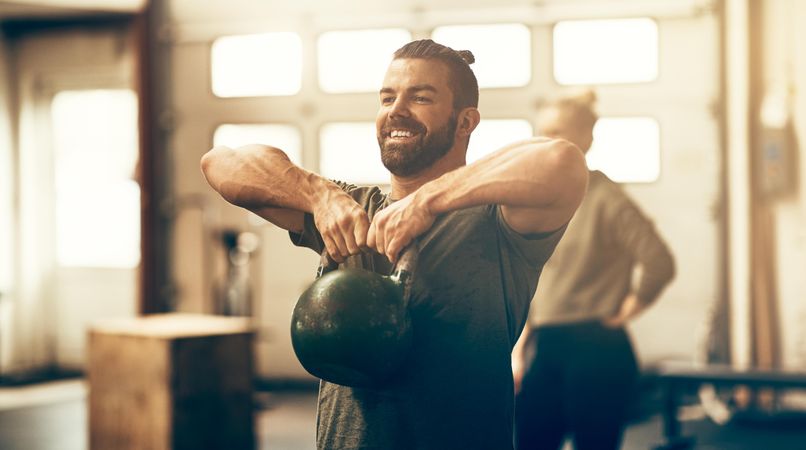 Man working out with kettlebell in gym