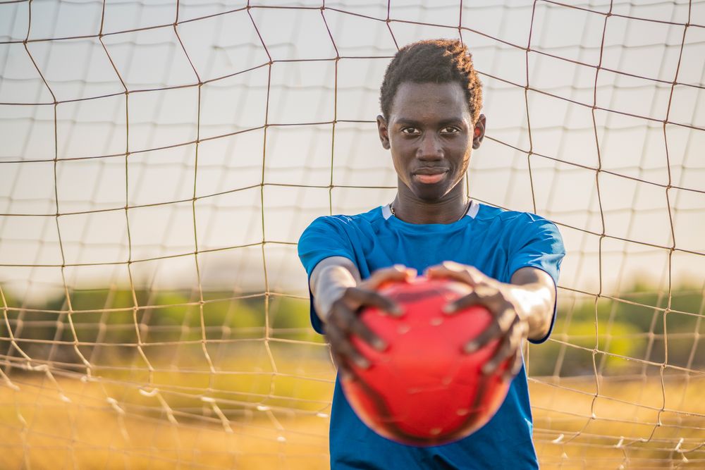 Black football player with ball