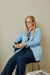 Woman in office looking at her mobile phone