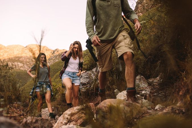 Group of friends walking through a mountain trail