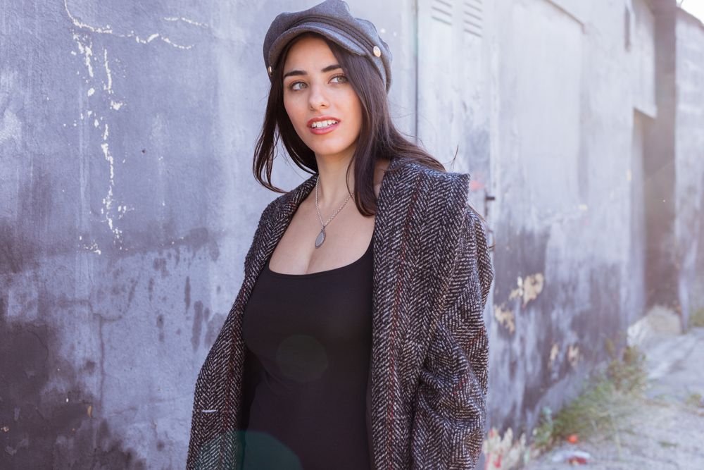 Charming Hispanic woman near wall