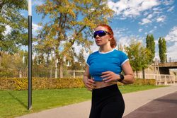 Young woman jogging in park, fitness routine.