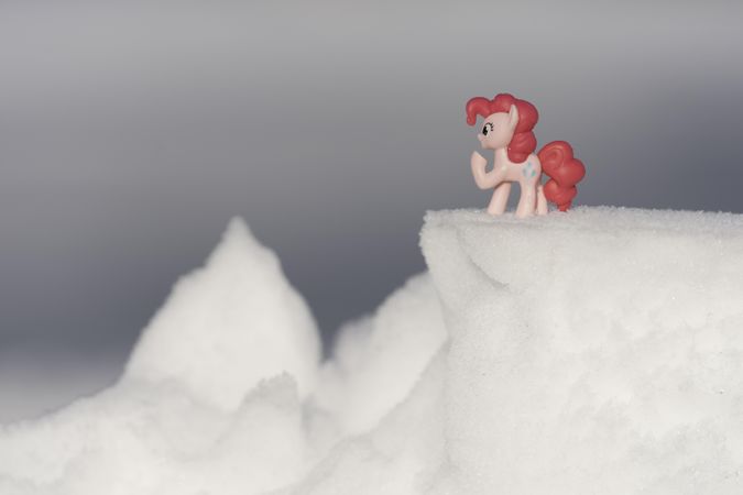 A surreal pony toy on the snow