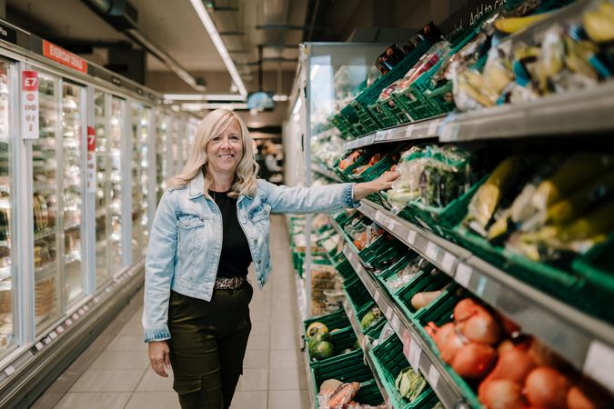 Mature woman shopping for produce at supermarket