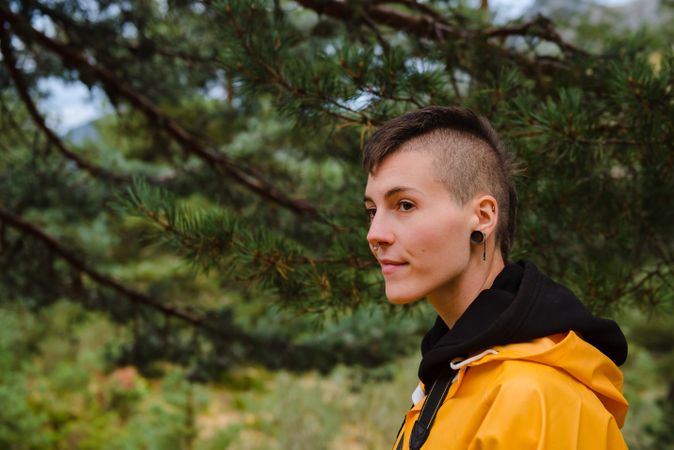 Person in yellow raincoat walking in forest
