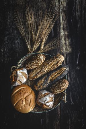 Assorted gold homemade bread on dark wood background