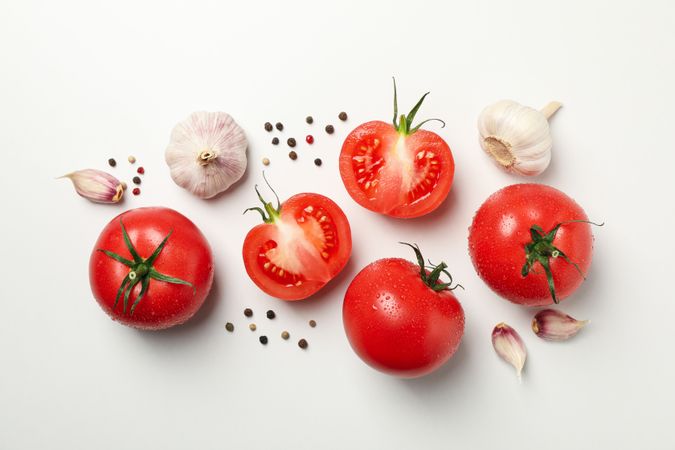 Tomatoes and ingredients on neutral background, top view