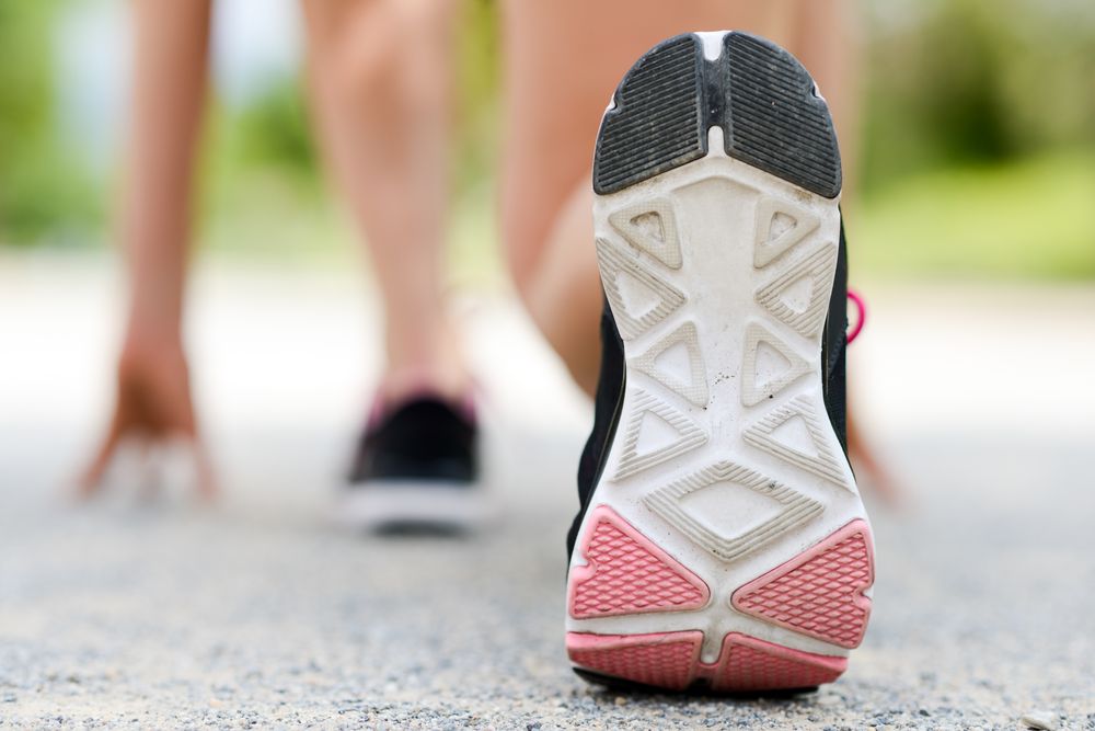 Sole of female athlete at starting line before sprint