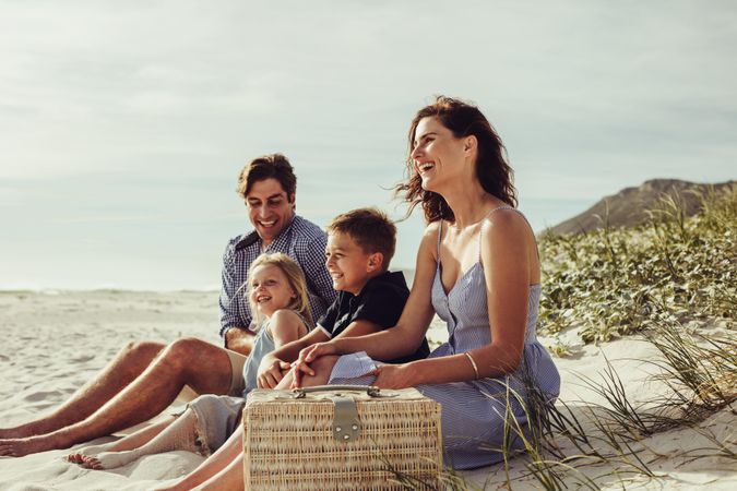 Family with kids sitting on the beach