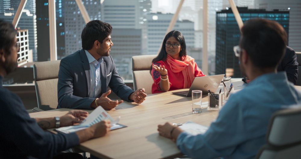 South Asian Colleagues Gathered Around a Conference Table.