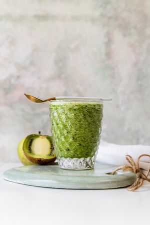 Healthy green smoothie near kiwi