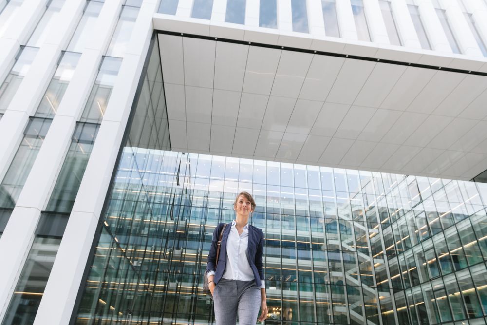 Happy female manager walking from work