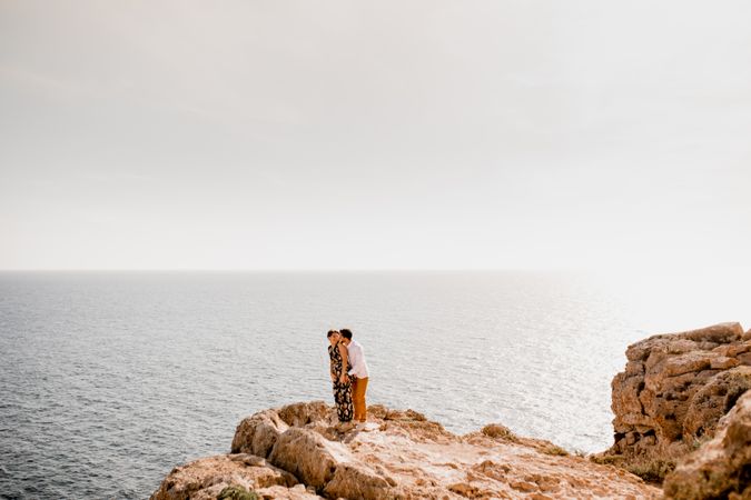 Couple embracing on rock