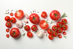 Composition with tomatoes and ingredients on light background, top view
