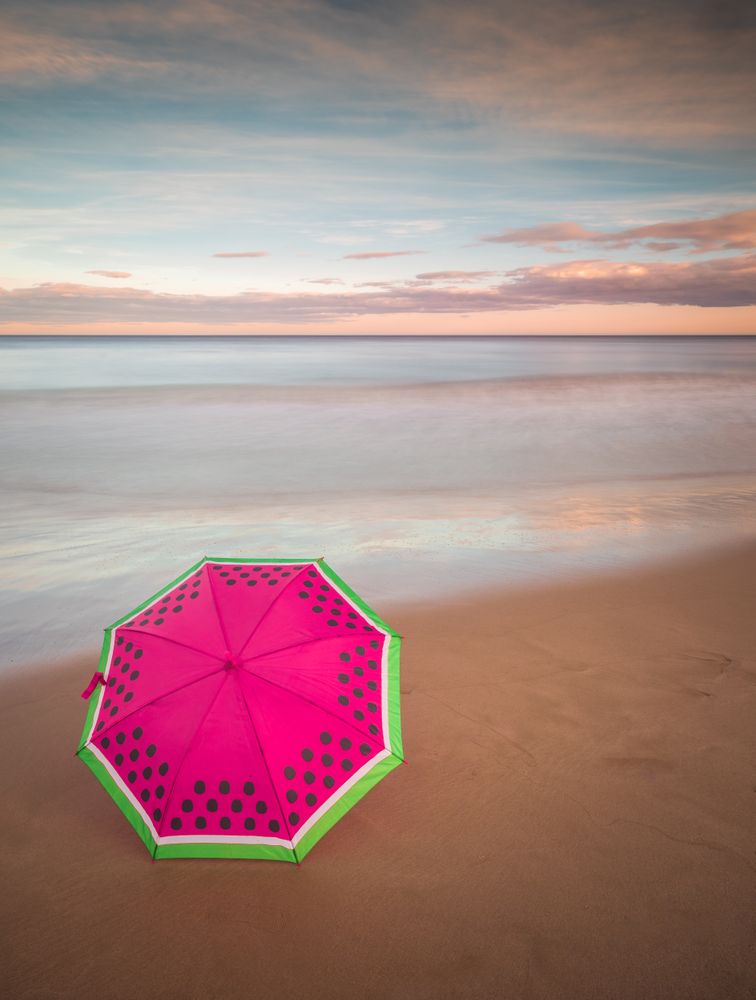 Umbrella on beach near sea