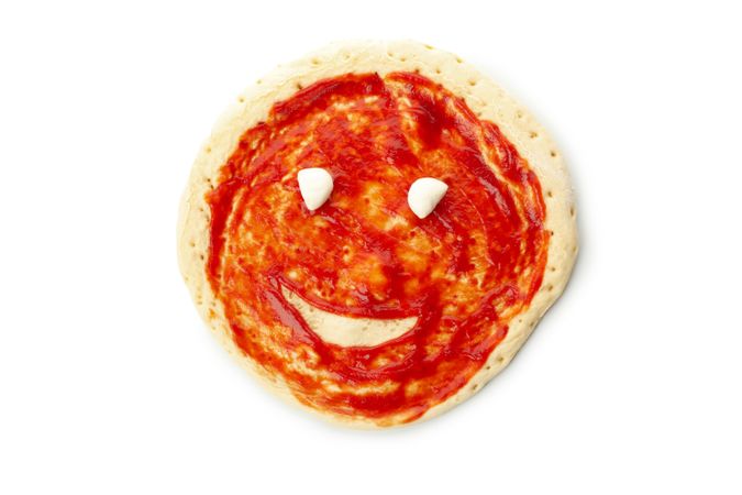 Pizza dough with sauce and smile isolated on blank background