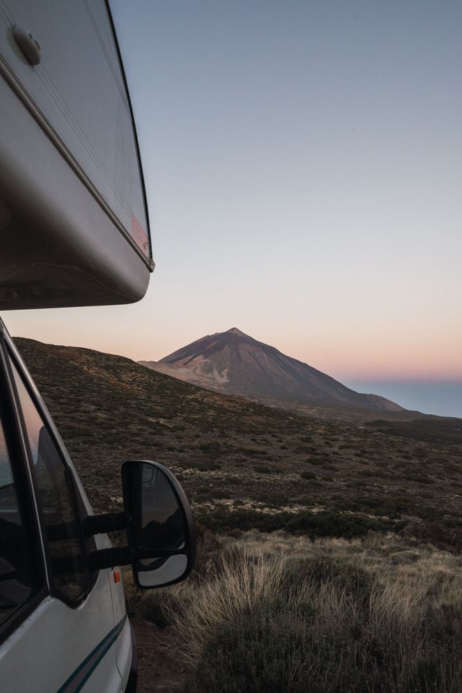 Camper car against remote mountain