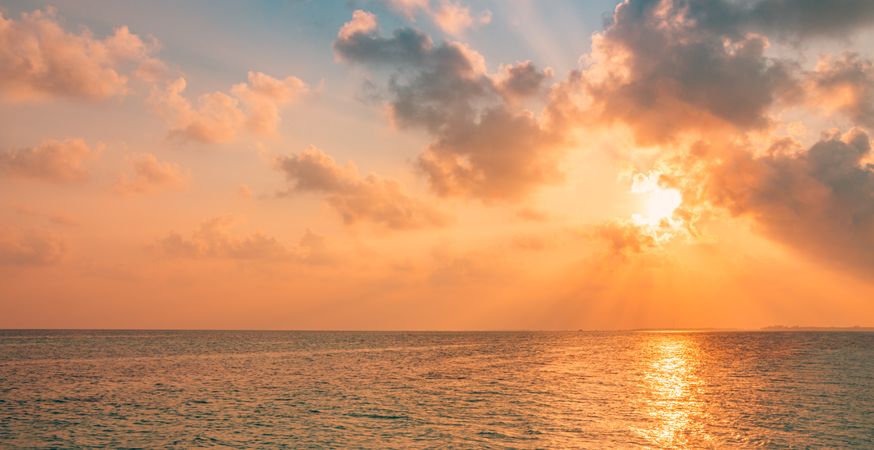 Peach tones in a sunset over the Indian Ocean, wide