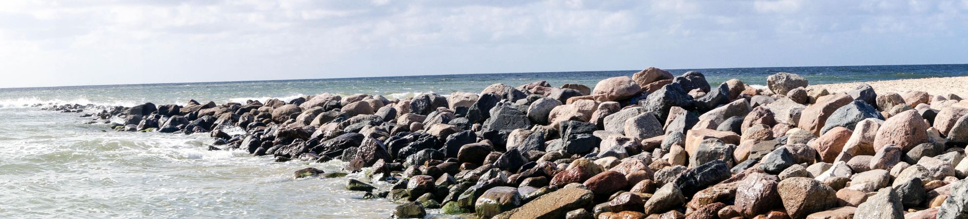 Rock wall in the water on seashore in Blavand, Denmark