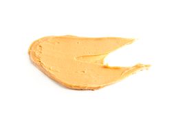 Creamy peanut butter isolated on bright background. A traditional product of American cuisine