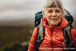 Portrait of woman standing outdoors on hiking trip 499LE4
