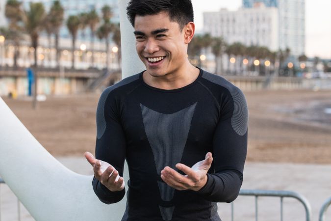 Cheerful athletic man with powdered hands