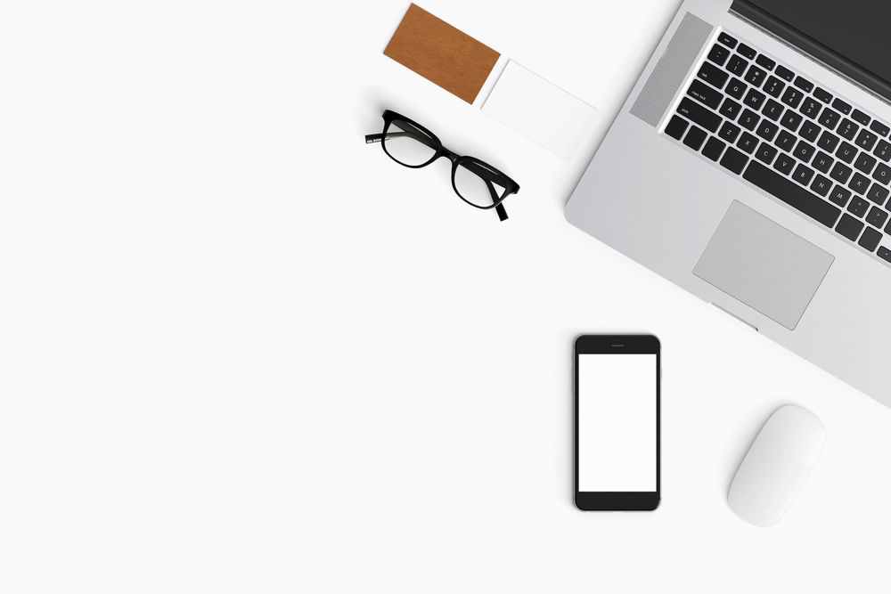 Modern workspace with coffee cup, smartphone, paper, notebook, tablet and laptop copy space