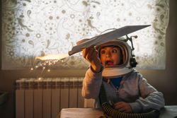 Dreamy kid having fun with toy airplane