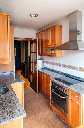 Kitchen on two fronts with wooden furniture