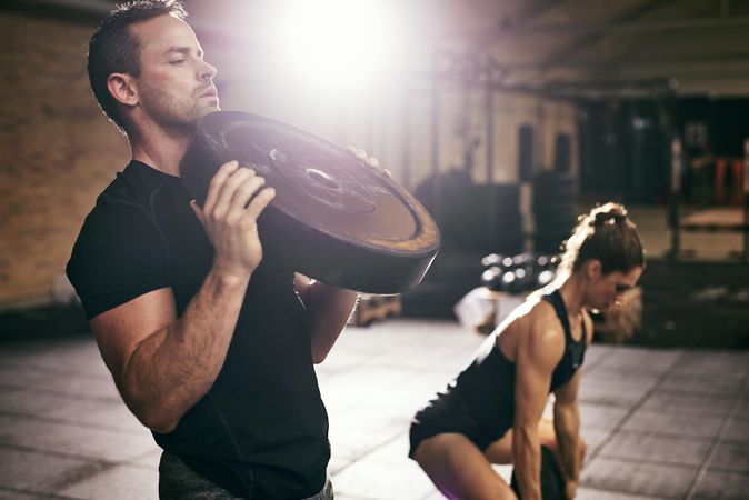 Crossfit couple using weights for strength training